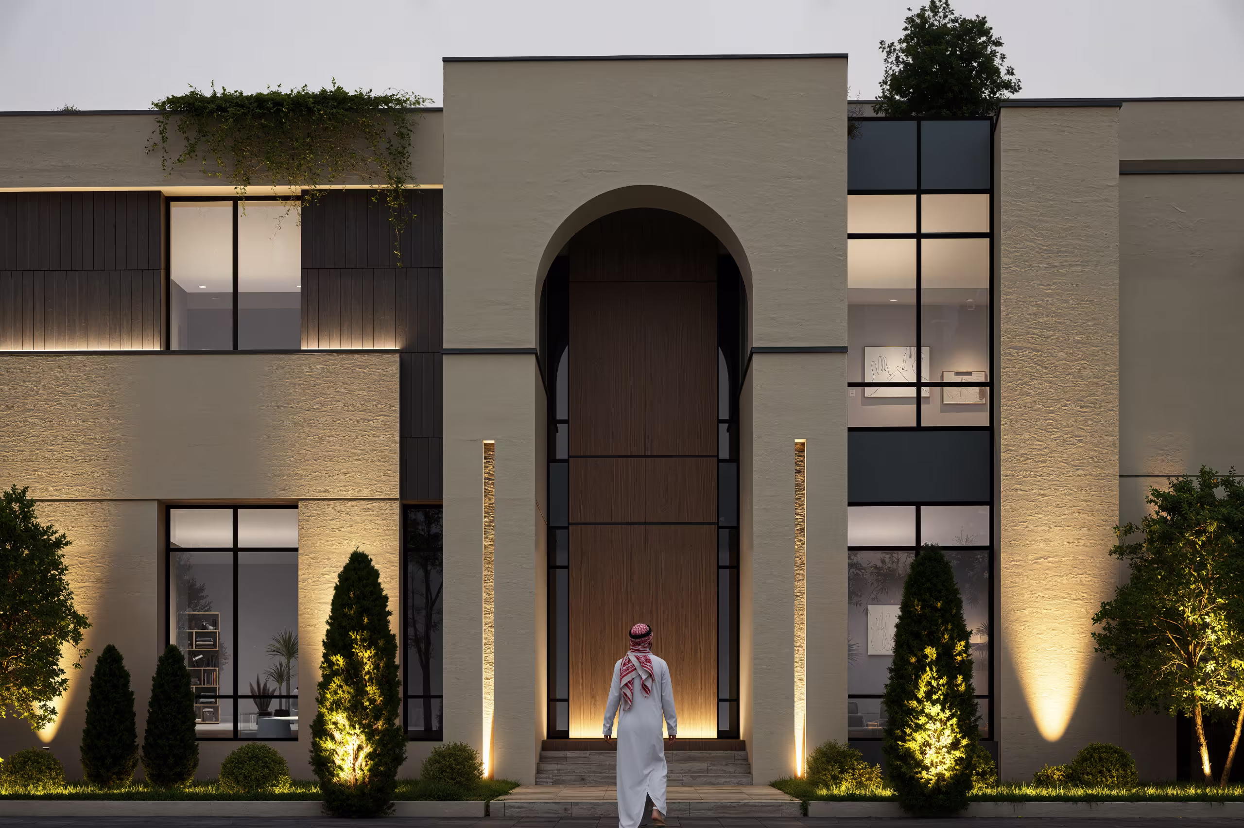 Modern street-facing villa with a tall entry volume, front wall, palms and layered planting