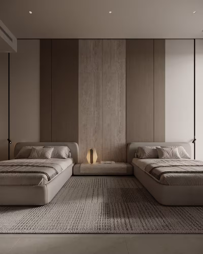 Twin bedroom with upholstered beds, full-height wall panels and warm bedside lighting