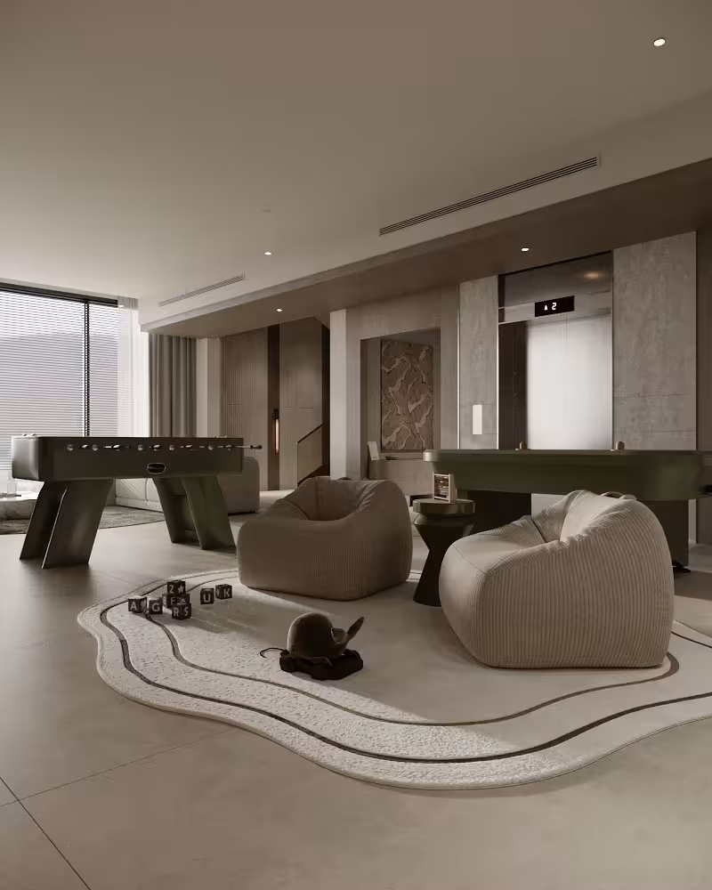 Recreation lounge with billiards table, soft seating, graphic rug and warm perimeter lighting