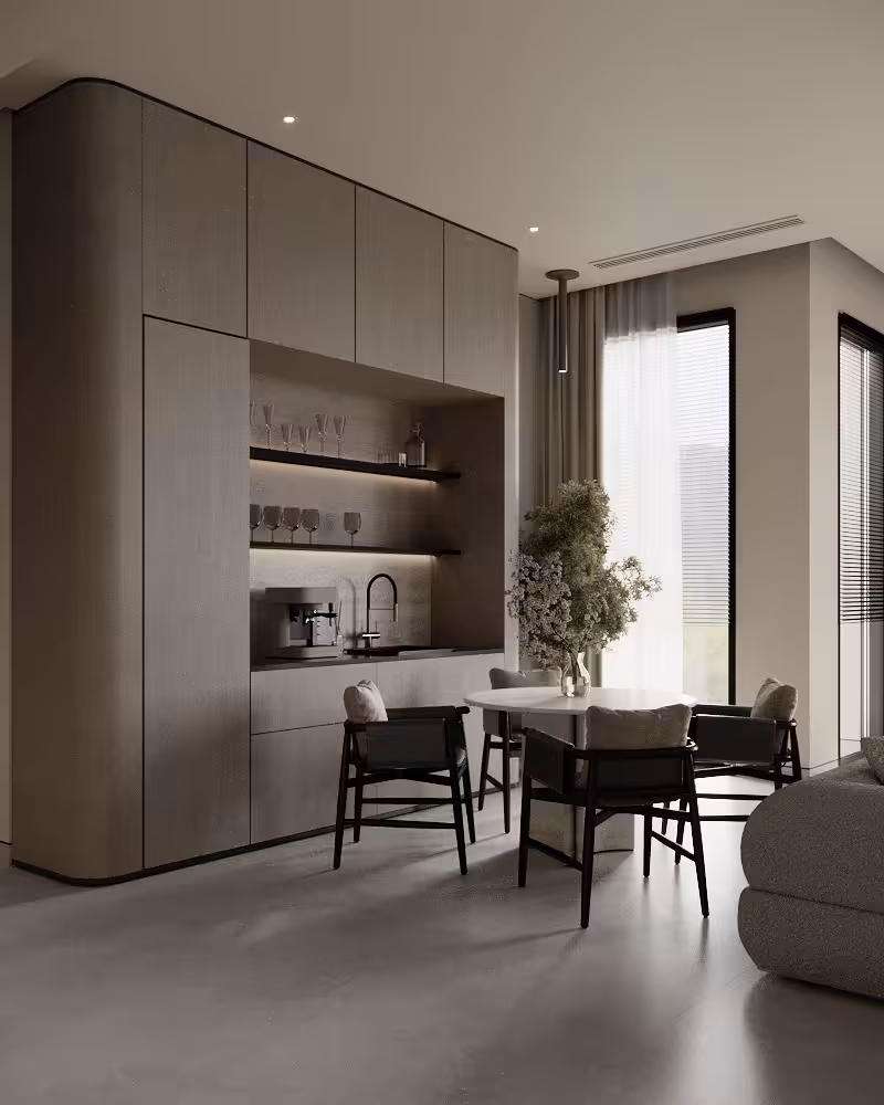 Dining nook beside a full-height beverage station with integrated shelving and soft daylight